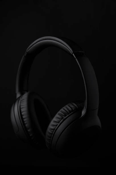 istock Black headphones on a black background 1493277356