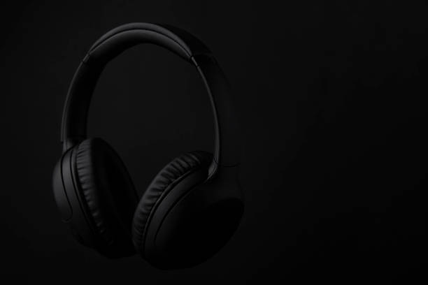 istock Black headphones on a black background 1493277361