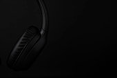 Detail of headphones with copy space on a black background.