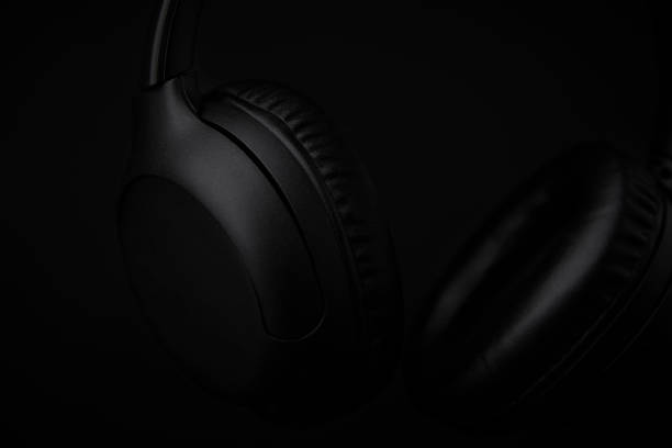 istock Black headphones on a black background 1493277390