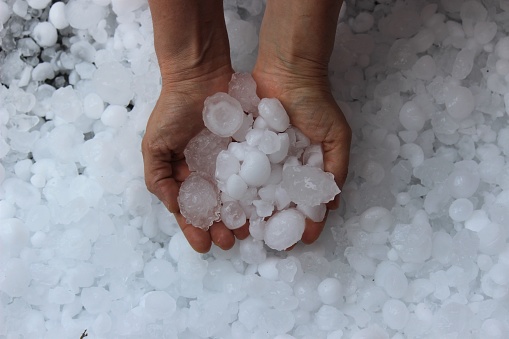 Woman holding hail stones in hand