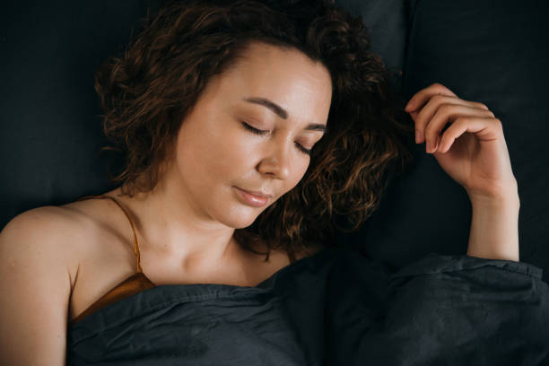 istock Woman sleeping on bed at home, close-up 1493279042