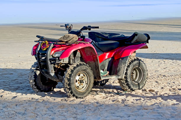 istock Red and black ATV parked on beach 1493280781