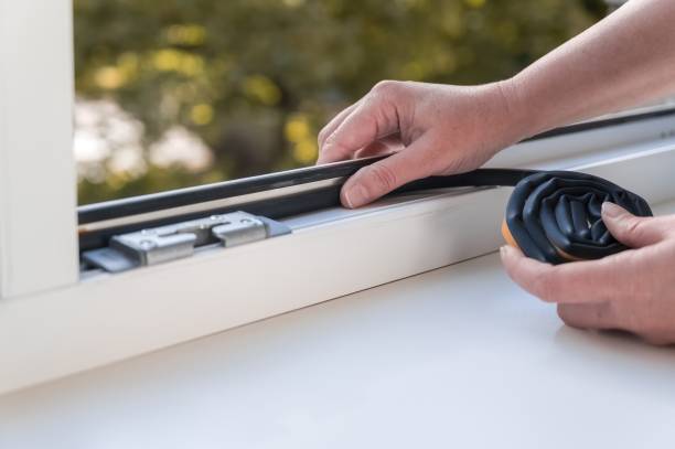 istock a person installing a window seal on a window. Heat saving concept. 1493282111
