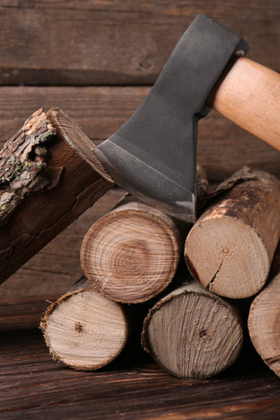 istock Metal ax and wooden logs on table 1493282116