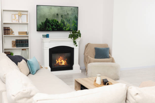 istock Stylish living room interior with cozy sofa, table, TV set and fireplace 1493282945