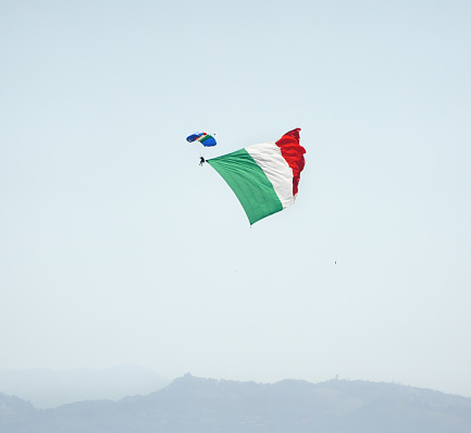 Rome, Lazio Italy - June 2, 2022  Skydiver with Italian flag over Rome to celebrate Festa della Repubblica.