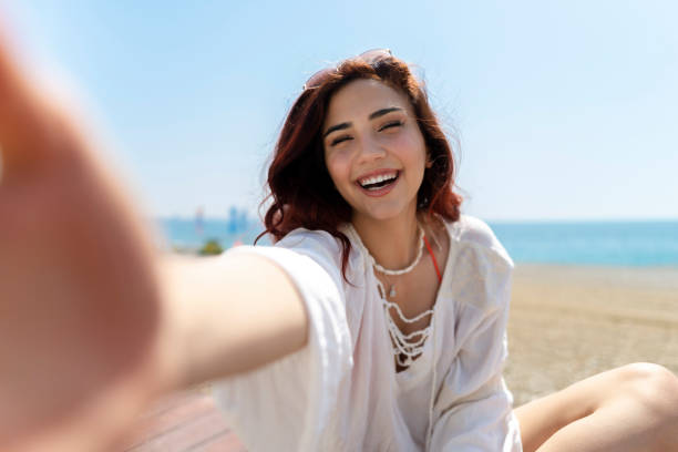 istock Woman taking selfie on the beach 1493286563