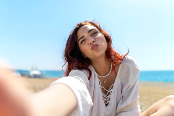 istock Woman taking selfie on the beach 1493286779