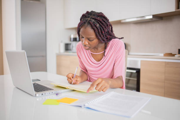 istock Happy young woman is learning online 1493287821
