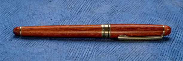 retro, elegant, rosewood ballpoint pen on a textured bark paper