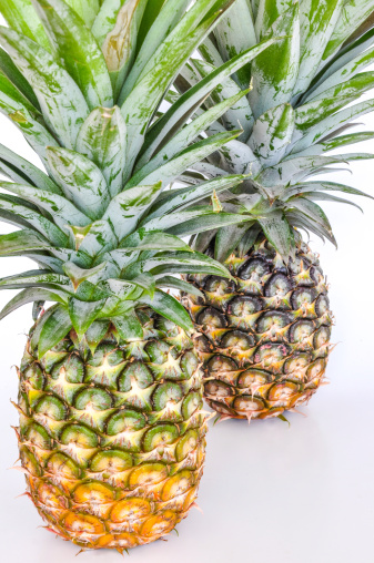 Fresh pineapples on white background.