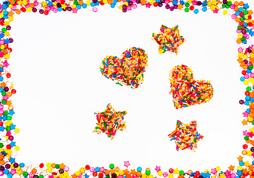 High angle view of sugar sprinkles on white background.