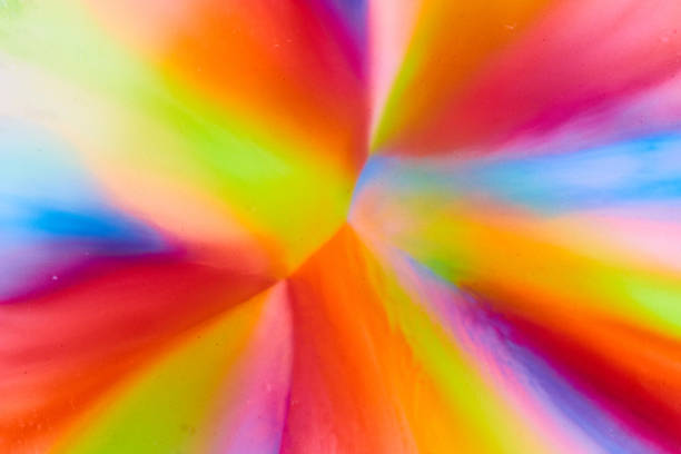 Image of Abstract rainbow from sugar in skittles mixed with water making candy colors pop on background asset