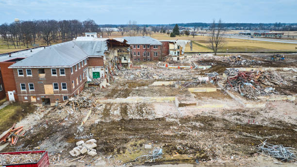 istock Destroyed building with boarded up windows and debris on the ground 1493303787
