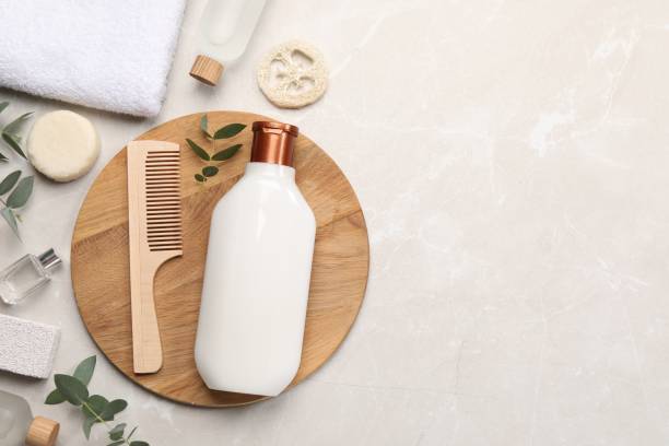 istock Flat lay composition with solid shampoo bar and bottle of cosmetic product on light grey table, space for text 1493304008