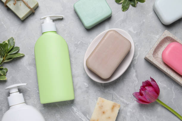 istock Flat lay composition with many different soap bars and bottle dispensers on light grey table 1493304926