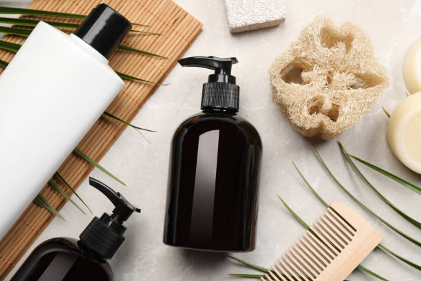 istock Flat lay composition with solid shampoo bars and bottles of cosmetic product on light grey table 1493305081