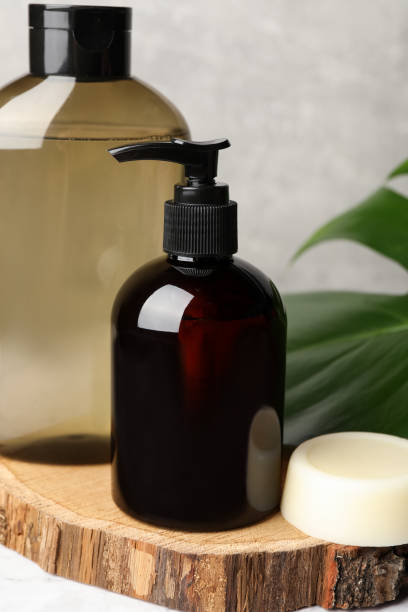 istock Solid shampoo bar and bottles of cosmetic product on white marble table, closeup 1493305682