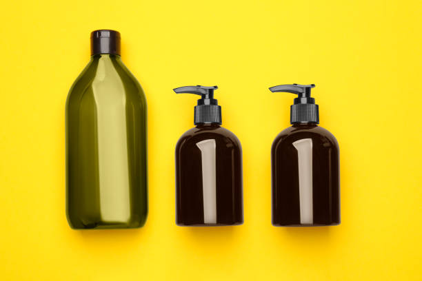 istock Bottles of shampoo on yellow background, flat lay 1493307452