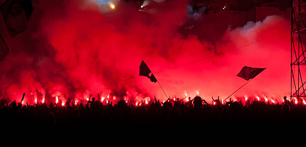 istock Fans burn red flares at rock concert 149331009