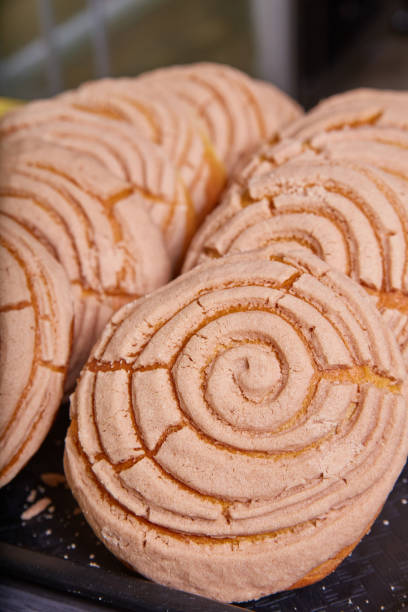 istock Mexican sweet bread conchas chocolate cocoa on black tray baked goods 1493310095