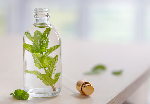 Bottle with fresh mint leaves
