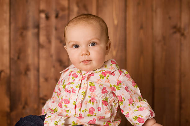 Portrait of cute baby girl at home. Little girl looking at the camera and smiling. Family, new life, childhood, beginning concept.