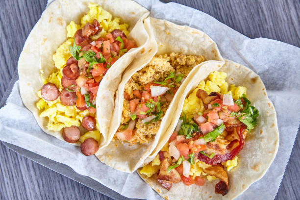 istock Three Hispanic breakfast tacos bacon sausage chorizo eggs on white simple background asset 1493311732