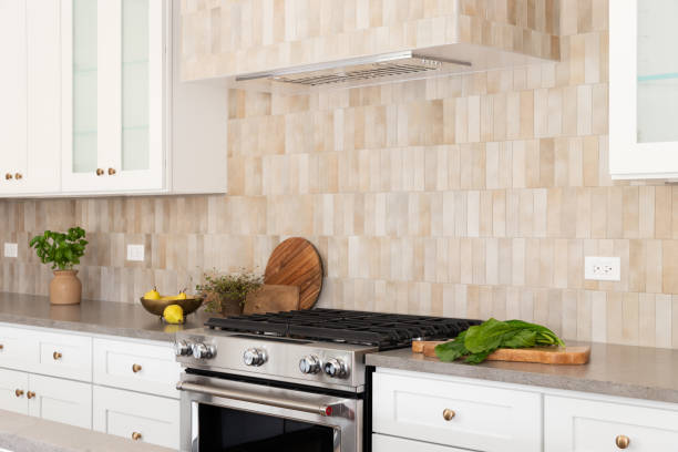 istock A kitchen stove and hood detail with brown rectangle tiles. 1493312227