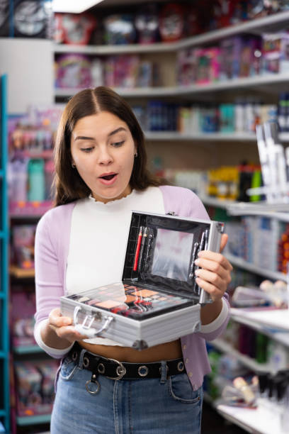 istock Woman with makeup and eye shadow set in cosmetics store 1493313800