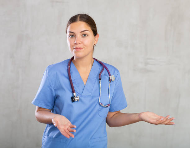 istock Smiling medical physician doctor in uniform posing on grey background 1493314893