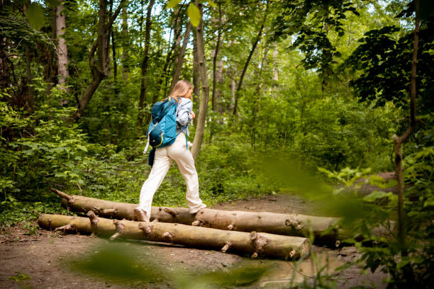 istock Young woman is walking through the forest 1493315935