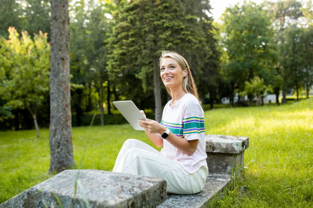 istock Woman is using a digital tablet in nature 1493316442