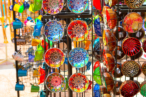 Sale of ceramic dishes at the oriental market . Traditional colored clay plates