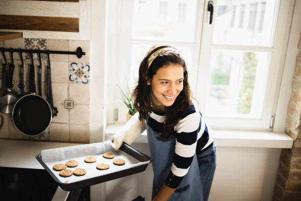 istock Young woman baking cookies 1493324356