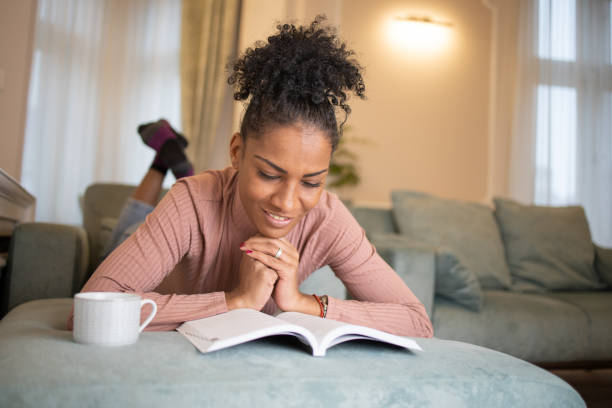 istock Woman relaxing and reading a book 1493324455