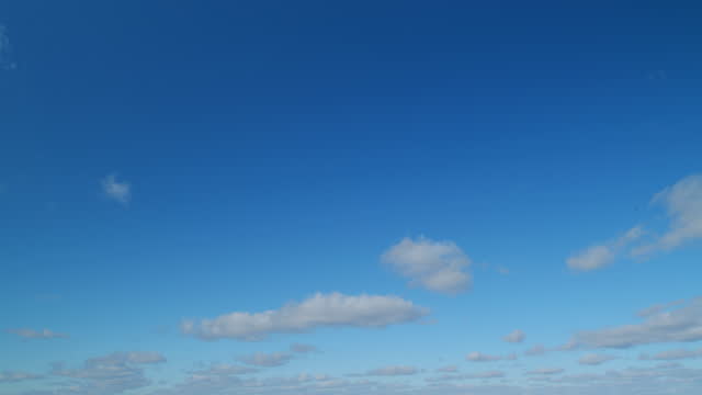 Blue sky with stratocumulus clouds. Beautiful clouds on blue sky on a sunny day background texture. Timelapse.