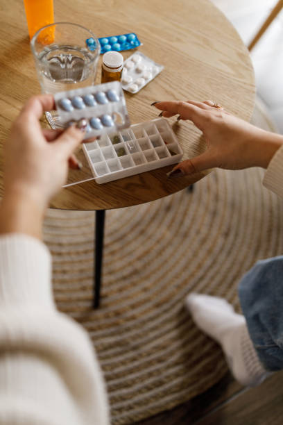 istock Unrecognizable young woman sorting out and organizing her medication for the week 1493326434