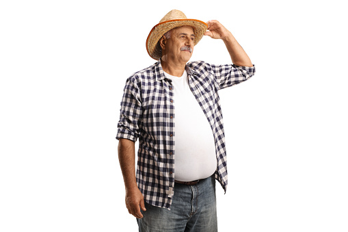 Mature farmer with a straw hat looking in distance isolated on white background