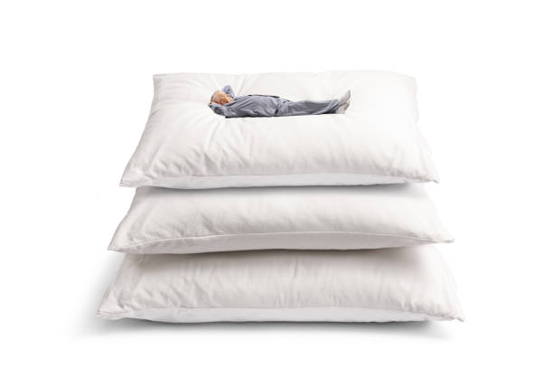 istock Mature man in pyjamas lying on a pile of pillows 1493336831