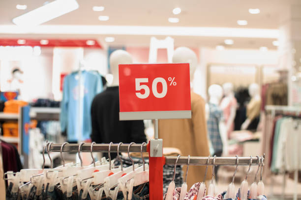 istock selective focus to red discount board with 50% writing. for discount templates for women's and men's clothing at the mall. soft focus 1493338776