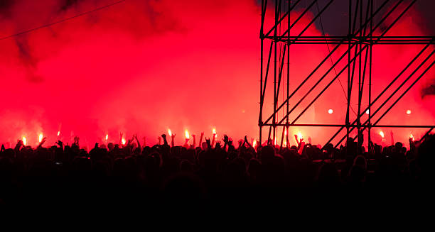 istock Fans burn flares at rock concert 149333932