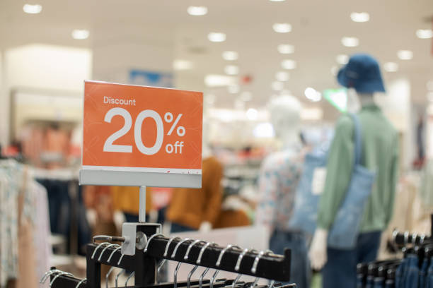 istock selective focus to red discount board with 20% writing. for discount templates for women's and men's clothing at the mall. soft focus 1493339334