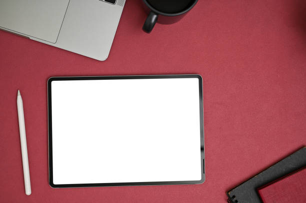 istock Modern creative office desk top view with digital tablet mockup on red tabletop 1493351698