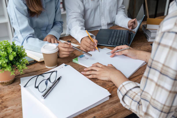 istock Distracted from preparing college project happy young laughing diverse classmates having fun, telling jokes, enjoying carefree pause time together, sitting at table in library 1493352319