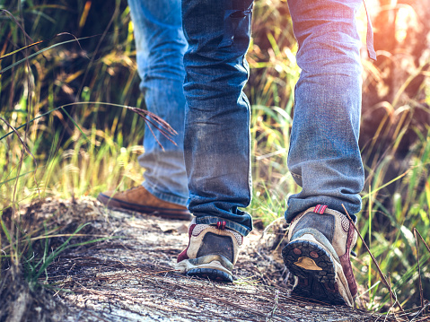 Close up shoes of two hiker man on mountain trail. travel concept.