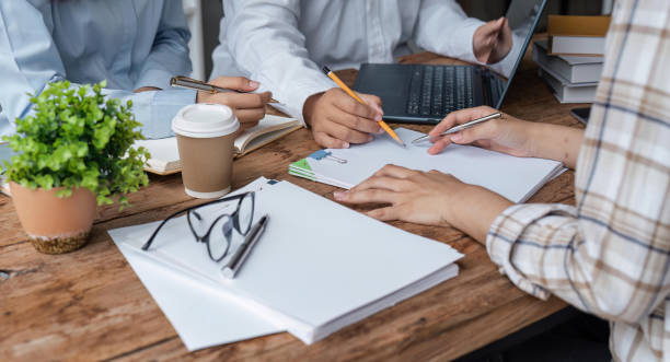 istock Education concept. Students studying and brainstorming campus concept. Close up of students discussing their subject on books textbooks and writing to notebook 1493354066