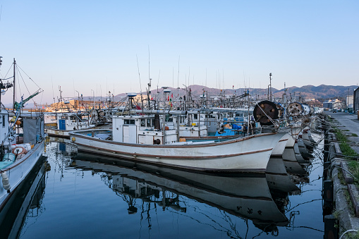 A group of fishing boats lined up at Wajima Port in Noto