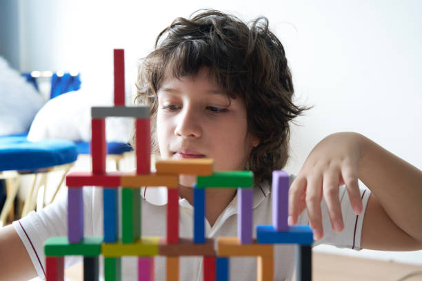 istock Cute Little Boy Playing with wooden block 1493355823